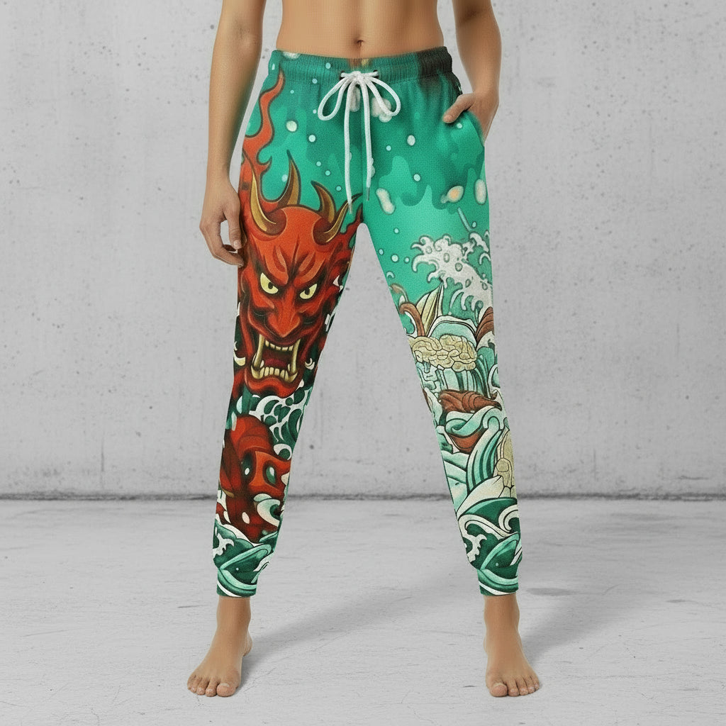 Black pants with colorful warrior design and gold accents on a white background